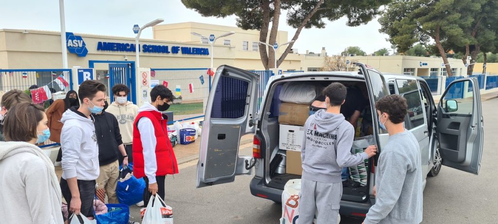 students loading items on a van
