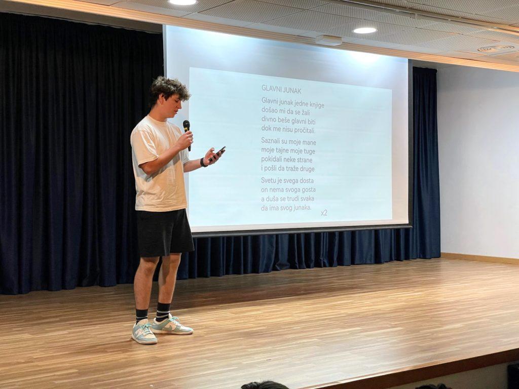 High School assembly: student reading a poem