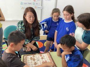 Students learning Chinese Chess